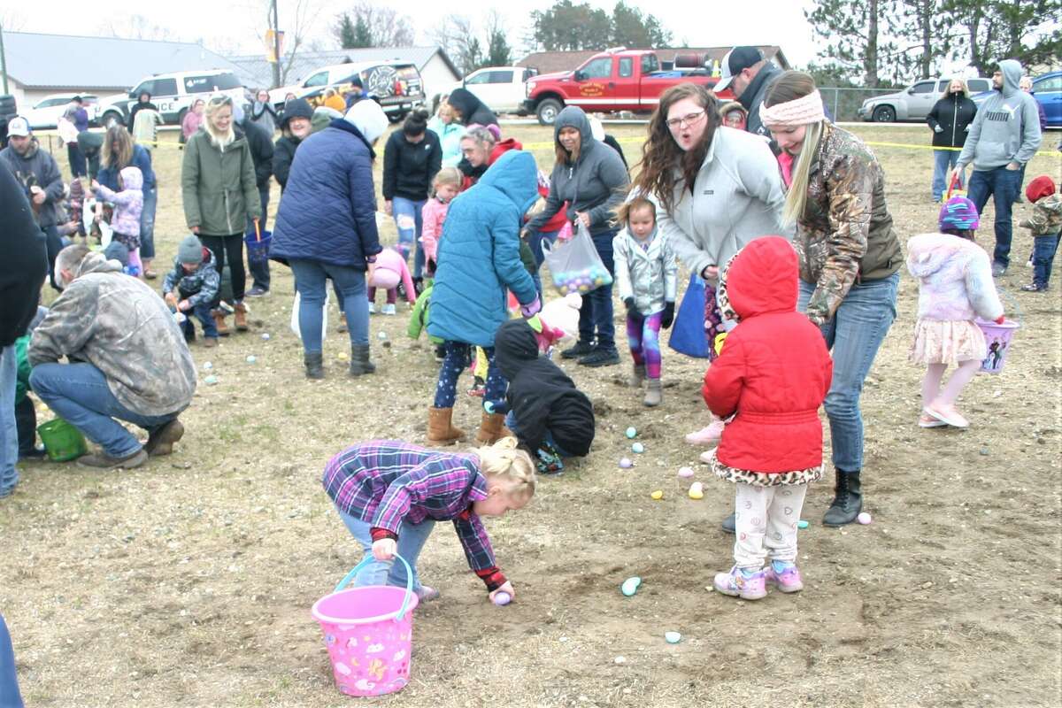 Cold, wind and even a little snow didn't keep the crowds from descending on the Evart High School grounds for the annual Easter Egg Drop. Weather prevented the helicopter from dropping eggs, but that didn't dampen the spirt as kids of all ages scrambled to collect thousands of candy-filled eggs scattered about the ground.