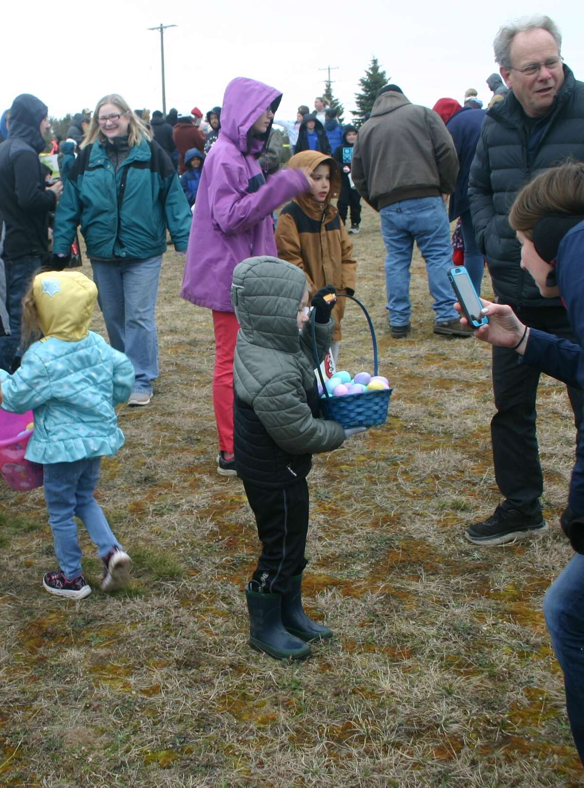 Cold, wind and even a little snow didn't keep the crowds from descending on the Evart High School grounds for the annual Easter Egg Drop. Weather prevented the helicopter from dropping eggs, but that didn't dampen the spirt as kids of all ages scrambled to collect thousands of candy-filled eggs scattered about the ground.