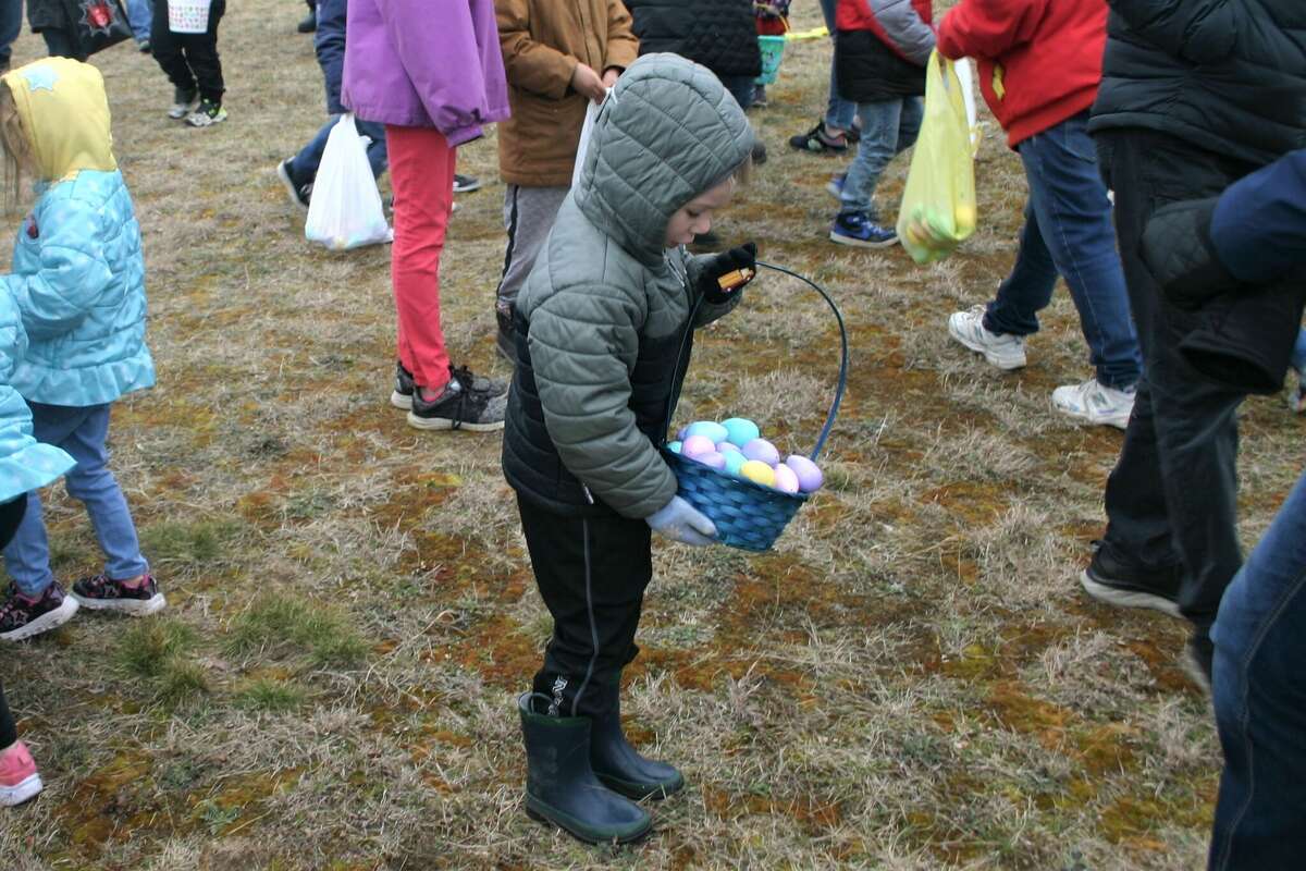 Cold, wind and even a little snow didn't keep the crowds from descending on the Evart High School grounds for the annual Easter Egg Drop. Weather prevented the helicopter from dropping eggs, but that didn't dampen the spirt as kids of all ages scrambled to collect thousands of candy-filled eggs scattered about the ground.