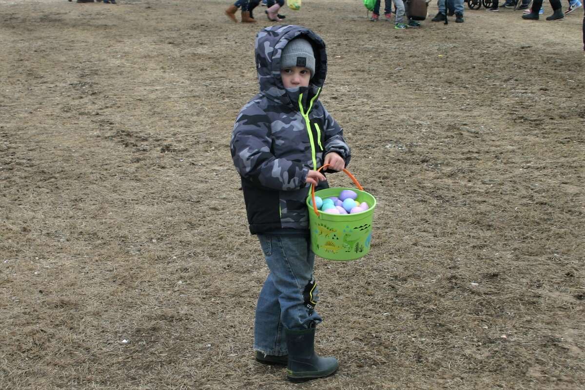 Cold, wind and even a little snow didn't keep the crowds from descending on the Evart High School grounds for the annual Easter Egg Drop. Weather prevented the helicopter from dropping eggs, but that didn't dampen the spirt as kids of all ages scrambled to collect thousands of candy-filled eggs scattered about the ground.