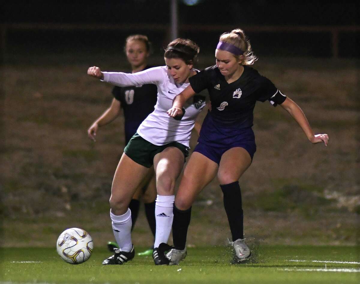Kingwood Park junior forward Olivia Roach, left, works the ball away from Montgomery senior Mable Pruter (8) during their District 20-5A matchup at MHS on Feb. 8, 2022.