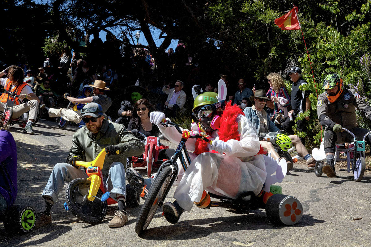 Costumed participants descend Vermont Street during the annual Bring Your Own Big Wheel event, on Sunday, April 17, in San Francisco. 