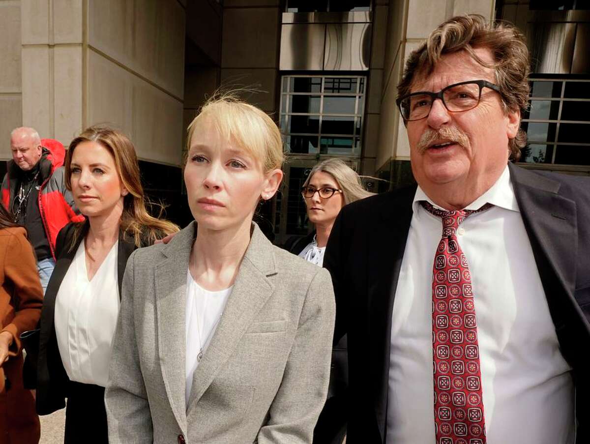 Sherri Papini of Redding leaves the federal courthouse accompanied by her attorney, William Portanova (right), in Sacramento on Wednesday. During a virtual hearing Monday, Papini accepted a plea bargain with prosecutors and pleaded guilty to a single count of mail fraud and one count of making false statements.