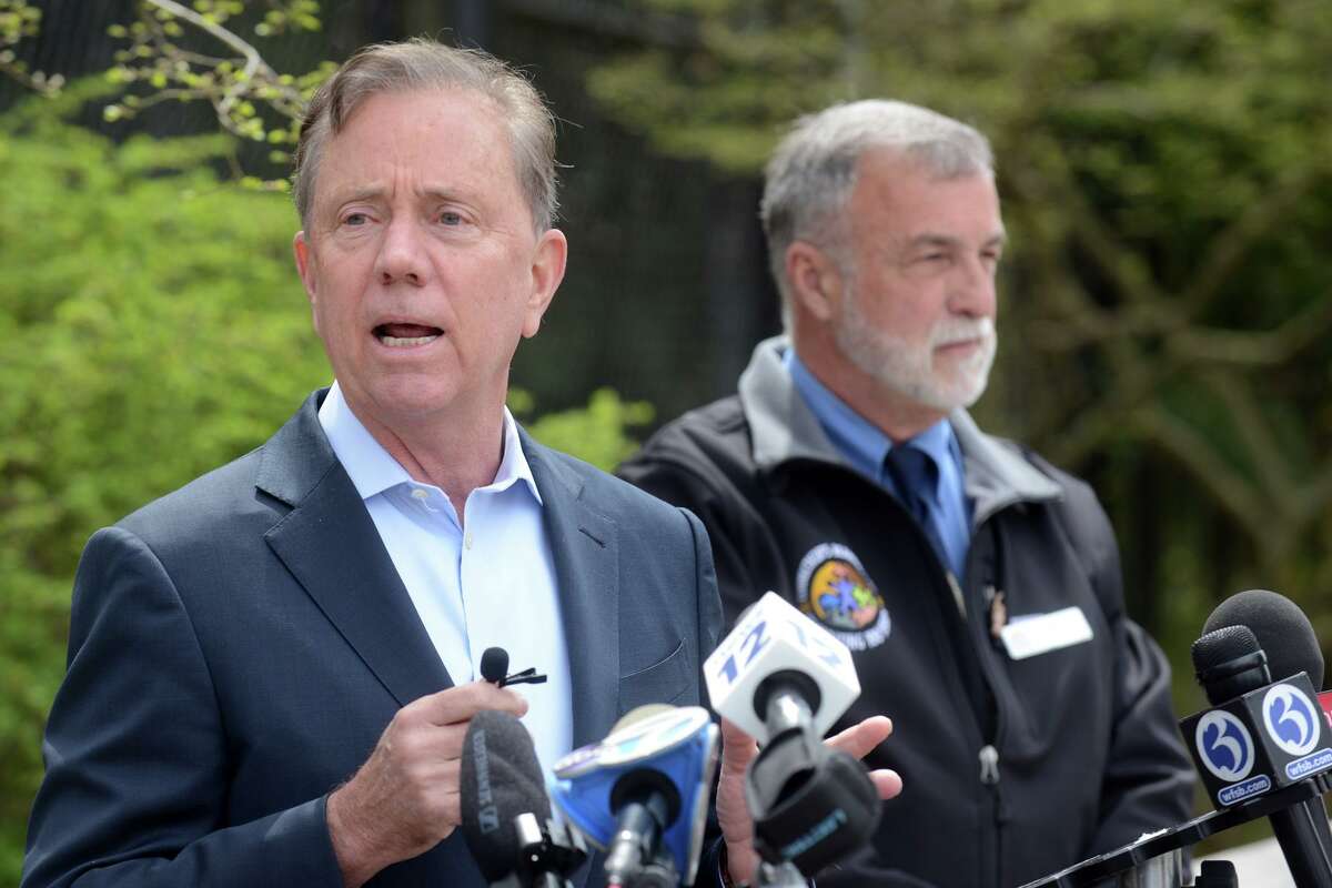 Gov. Ned Lamont speaks during a new conference at Connecticut’s Beardsley Zoo, in Bridgeport, Conn. April 18, 2022. Lamont, seen here with Zoo Director Gregg Dancho, announced $4.1 million in state funding to upgrades and renovations at the zoo.
