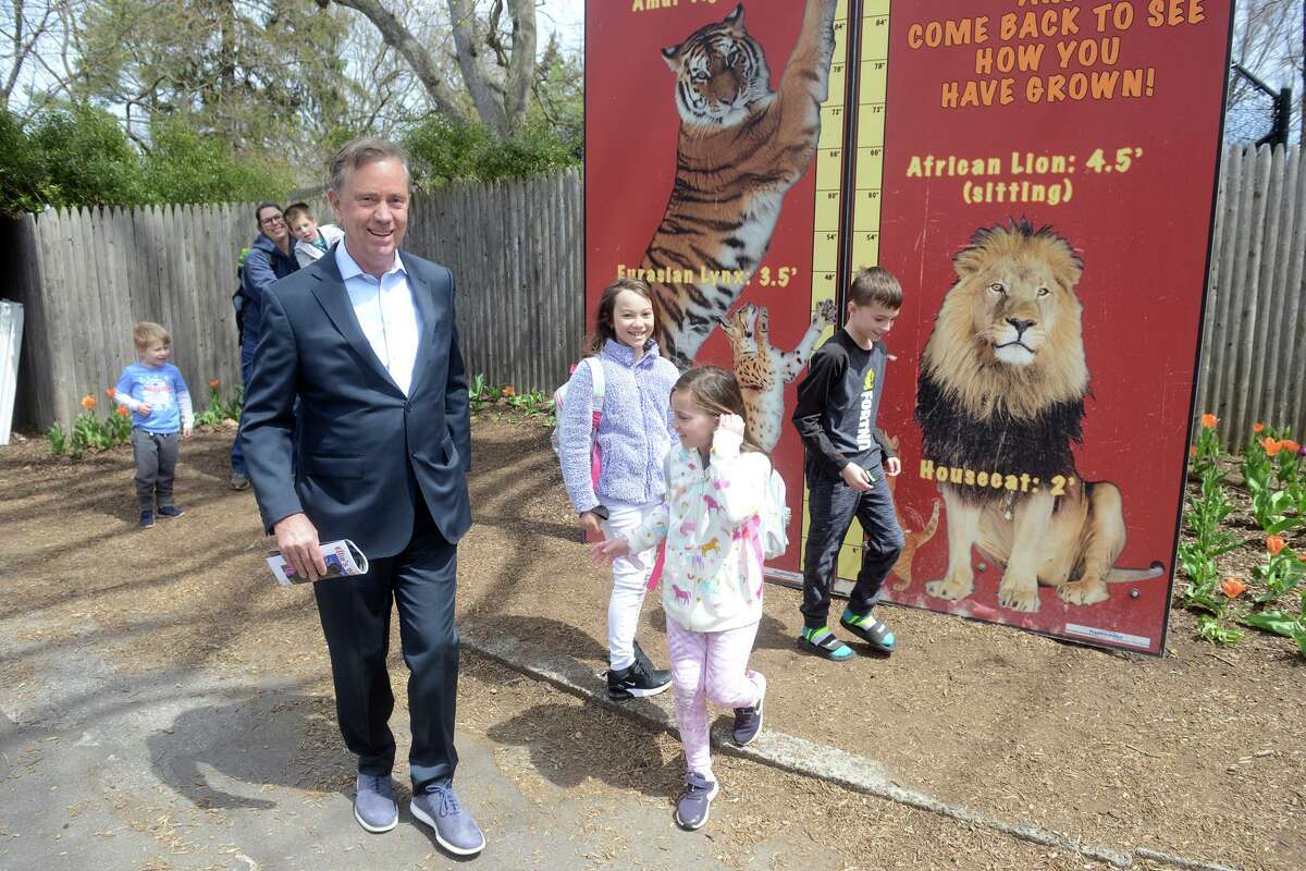 Gov. Ned Lamont greets a group of children during a visit to Connecticut’s Beardsley Zoo, in Bridgeport, Conn. April 18, 2022. Lamont visited the zoo Monday to announce $4.1 million in state funding to upgrades and renovations.