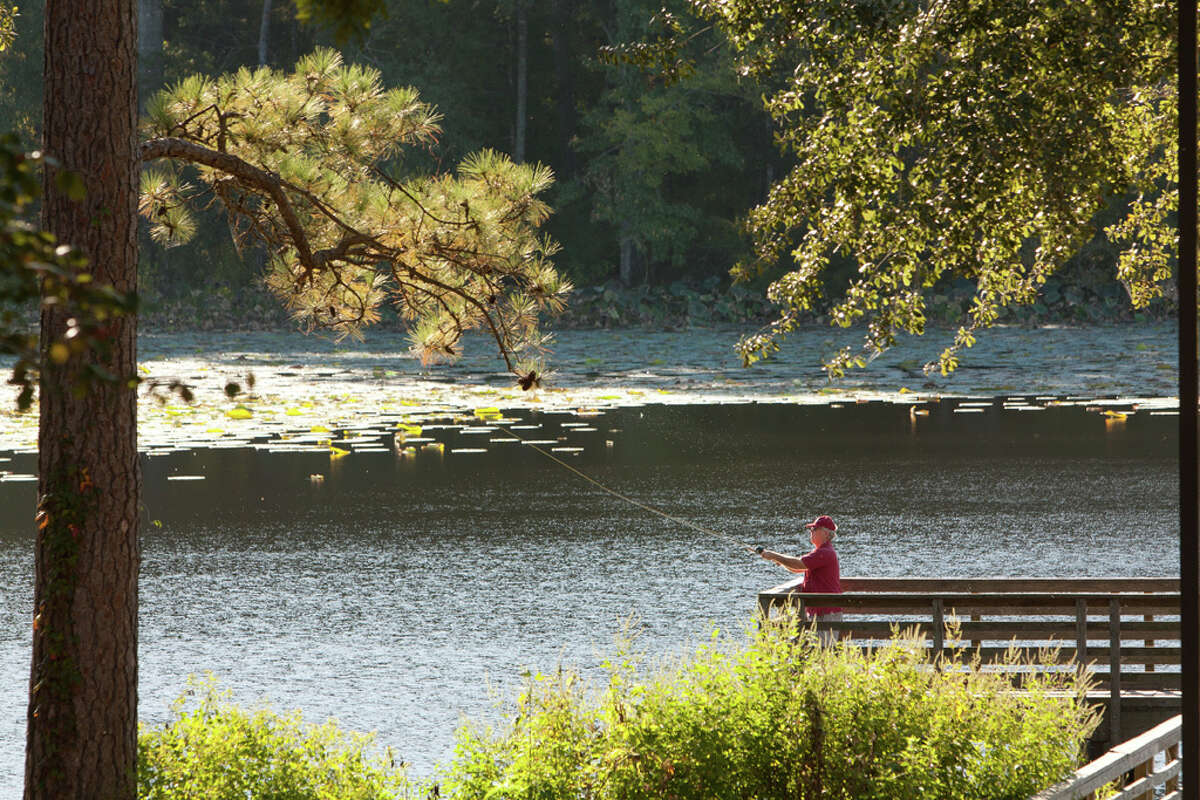 A man fishes on a dock at Huntsville State Park. 