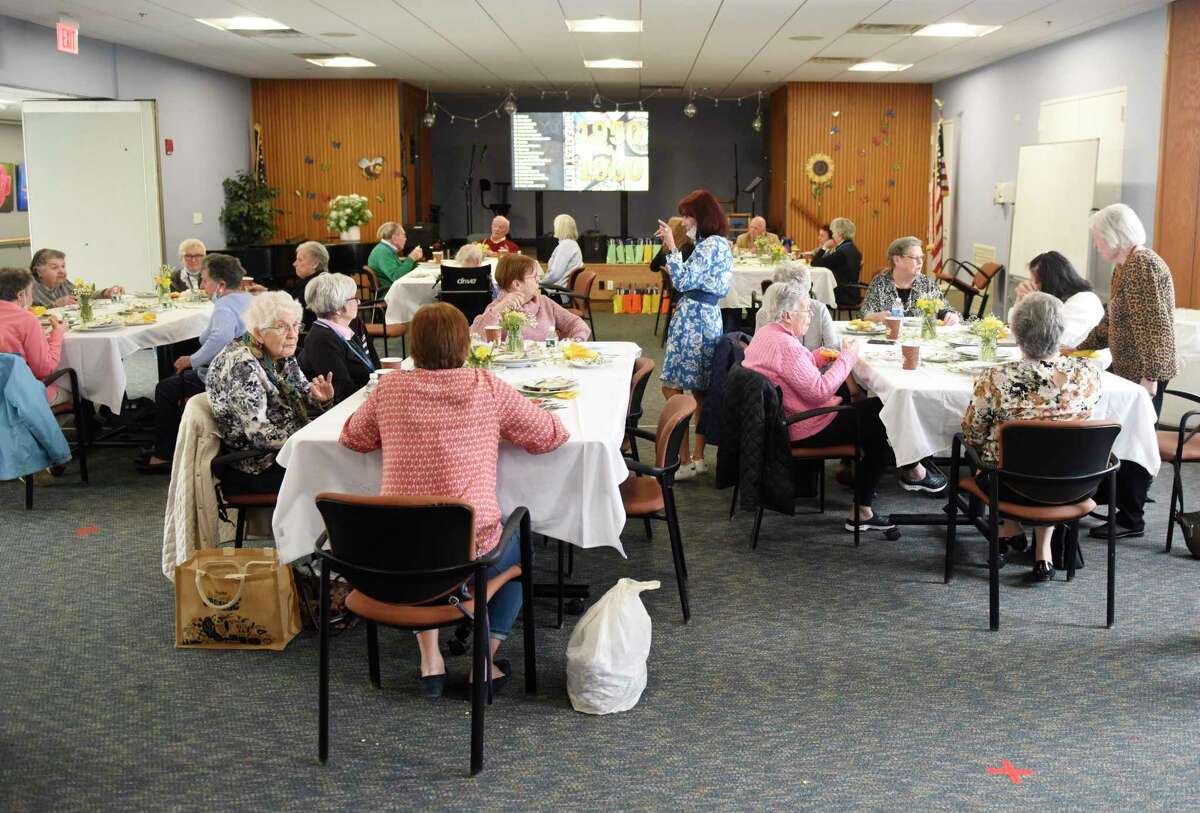 Volunteers eat lunch during National Volunteer Week at The Nathaniel Witherell nursing and rehabilitation center in Greenwich, Conn. Monday, April 18, 2022. This week is National Volunteer Week and The Nathaniel Witherell held a special lunch to thank the dozens of volunteers that help the facility run smoothly.
