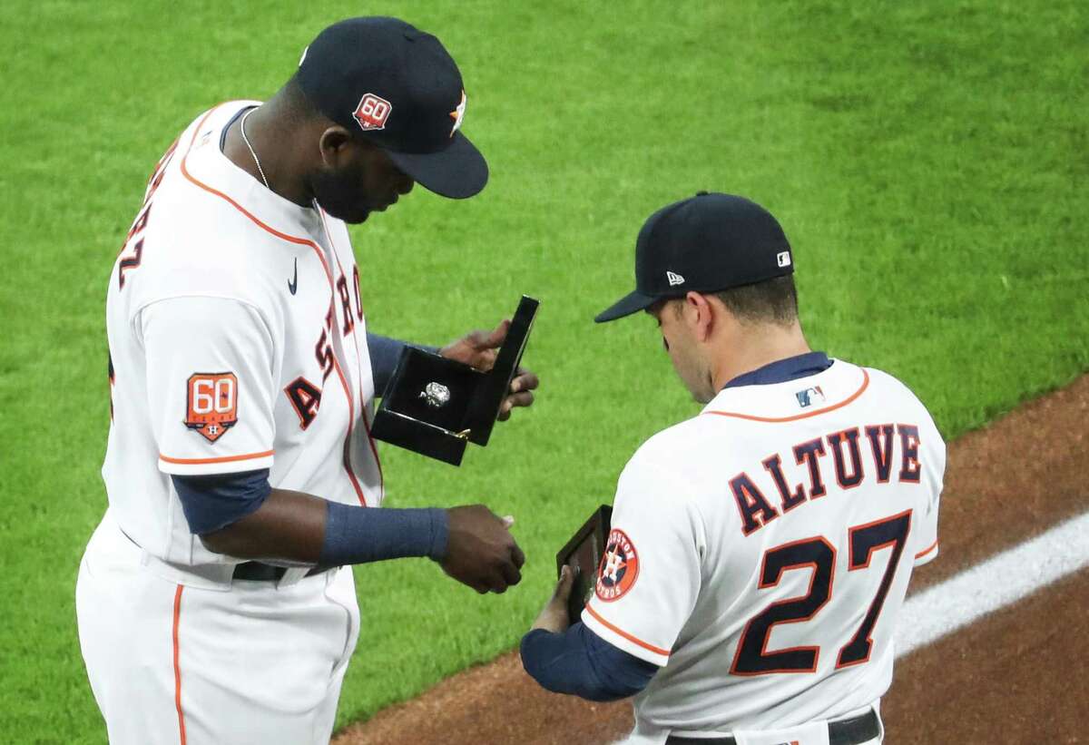 Yordan Alvarez and Jose Altuve examine their 2021 American League championship rings before the Astros’ home opener Monday night.