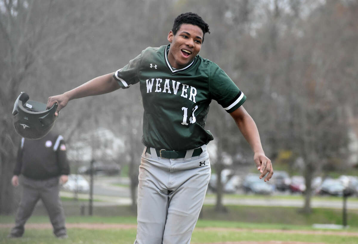 Weaver's Jashaun Richardson celebrates after scoring a run during a baseball game between Weaver and Civic Leadership at Weaver high school, Hartford on Monday, April 18, 2022.