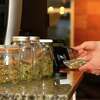 Paying by credit card for marijuana at a cannabis dispensary. Getty Images.