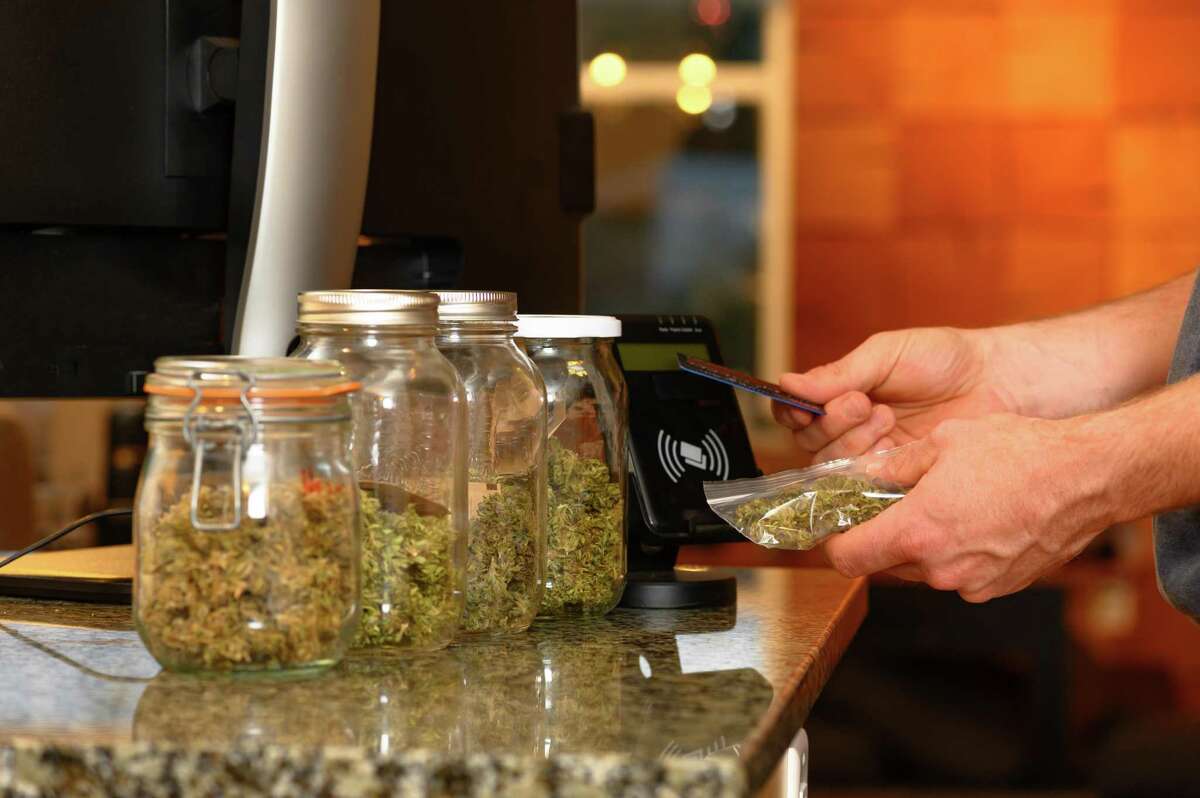 Paying by credit card for marijuana at a cannabis dispensary. Getty Images.