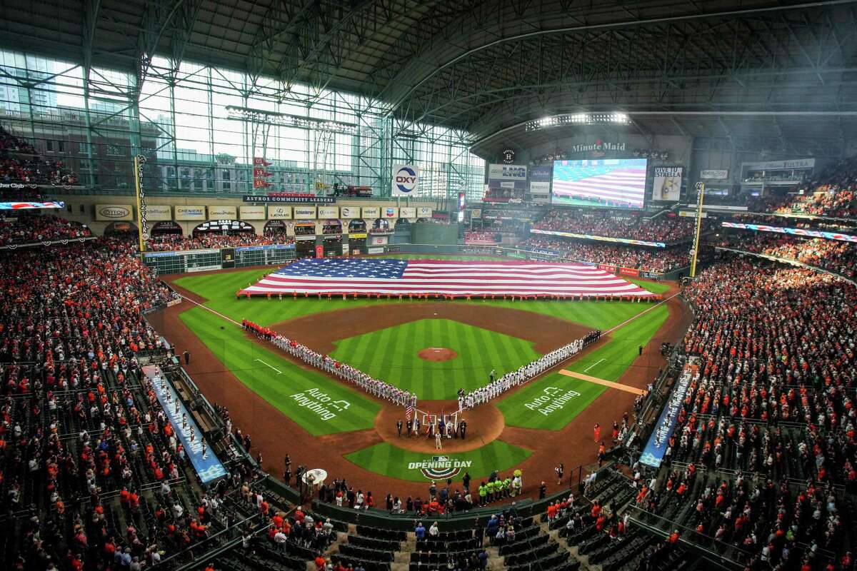 Houston Astros fans unfurl an outfield-sized American flag before the Astros home opener against the Los Angeles Angels Monday, April 18, 2022, at Minute Maid Park in Houston.