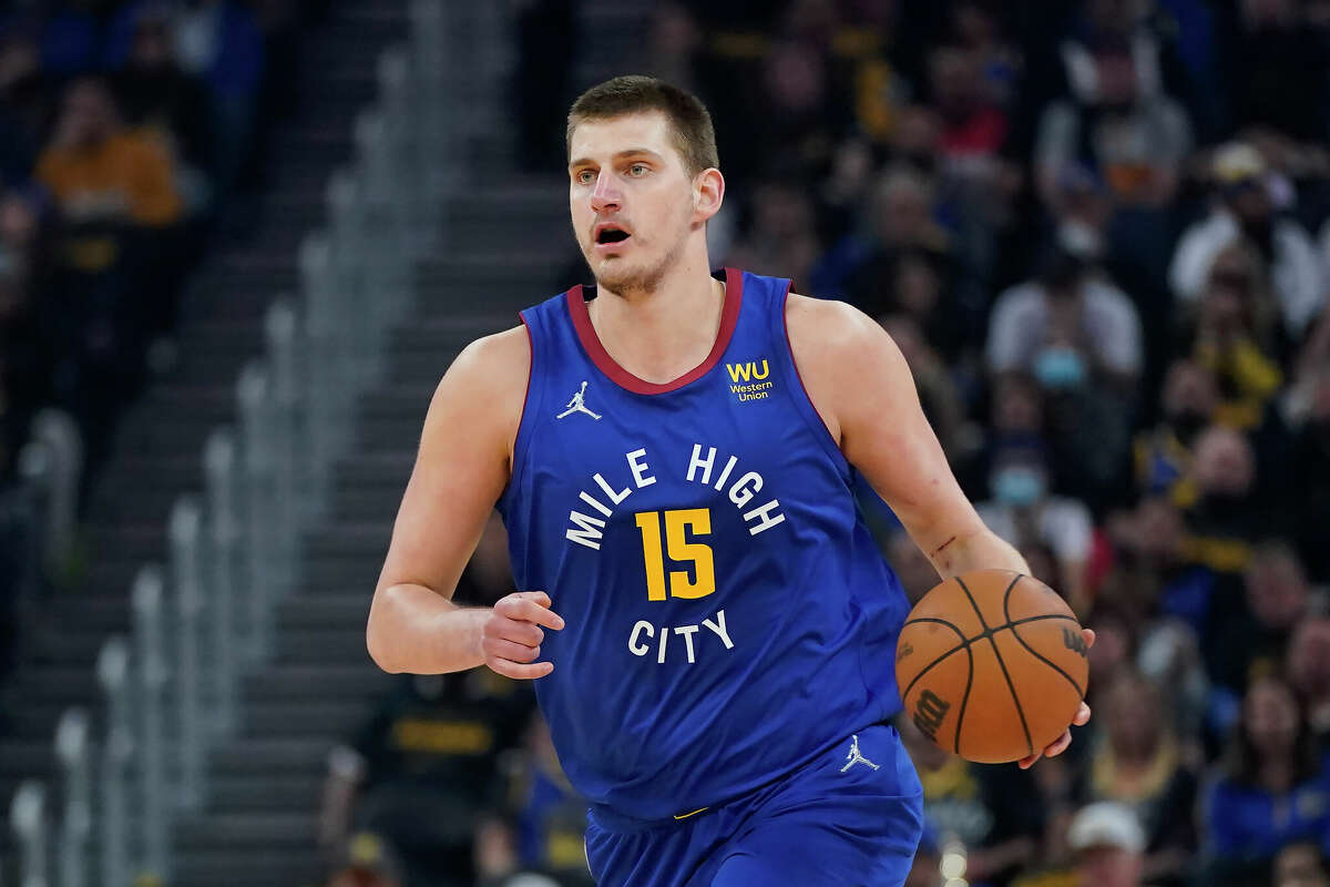 Denver Nuggets center Nikola Jokic dribbles the ball up the court against the Golden State Warriors during the first half of Game 2 of an NBA basketball first-round playoff series in San Francisco, Monday, April 18, 2022. 