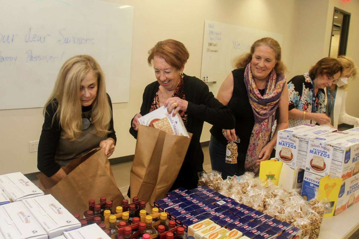 Sandy Lessig, from left, Susan Marblestone and Karen Kessler assemble bags for Holocaust survivors for the upcoming Yom HaShoah observance (or Holocaust Remembrance). They were assembling the bags at Holocaust Museum Houston on April 12, 2022. During this annual commemoration, the community mourns the loss of the 6 million Jewish people who perished in the Holocaust, honors those who survived and come together to remember and reflect.