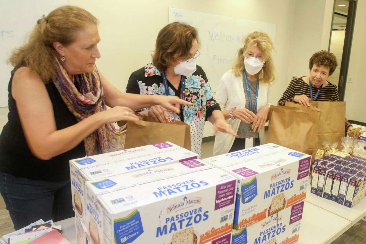 Karen Kessler, from left, Judy Myers, Marsha Hurwitz and Rhoda Goldberg assemble bags for Holocaust survivors for the upcoming Yom HaShoah observance (or Holocaust Remembrance). They were assembling the bags at Holocaust Museum Houston on April 12, 2022. During this annual commemoration, the community mourns the loss of the 6 million Jewish people who perished in the Holocaust, honors those who survived and come together to remember and reflect.