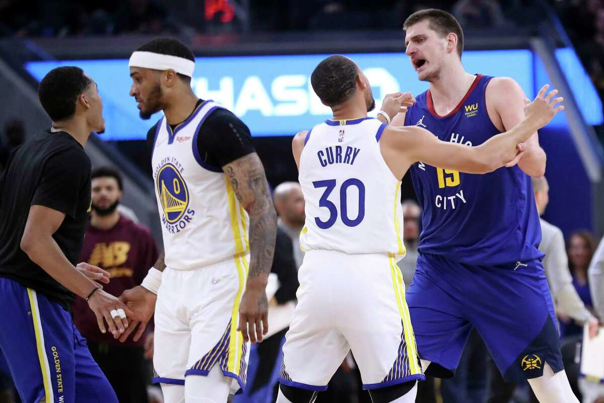 Golden State Warriors' Stephen Curry prevents Denver Nuggets' Nikola Jokic from going after Gary Payton II in the first quarter of Game 2 against the Denver Nuggets of an NBA basketball first-round playoff series in San Francisco, Monday, April 18, 2022.