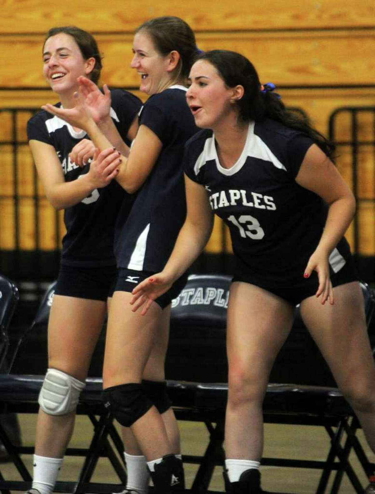 From left, Staples' Kristen Weiler, Melissa Sweeney and Audrey Stone cheer for their team during Wednesday's game against Darien at Staples High School on September 29, 2010.