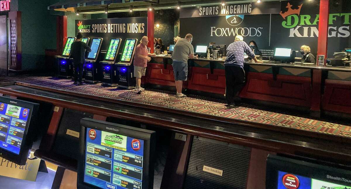 Gamblers place their bets on sports for the first time at Foxwoods Resort Casino in Mashantucket, Conn., Thursday Sept. 30, 2021.