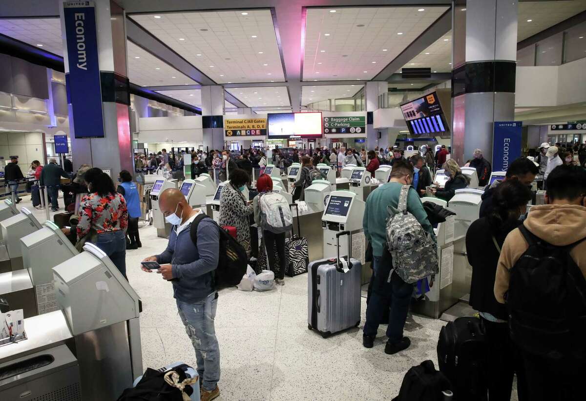 Passengers check in for flights ahead of the Thanksgiving holiday Tuesday, Nov. 23, 2021, in Terminal C at George Bush Intercontinental Airport in Houston.