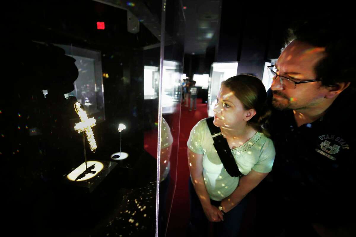Anita and Jarod Younker look at Pope Paul VI’s Cross and Ring at Houston Museum of Natural Science April 13, 2022, in Houston. Pope Paul VI’s Cross and Ring has been on display for the first time since April 11th. The Pectoral Cross and Ring has been worn by His Holiness Pope Paul VI, John XXIII and Pius XII.