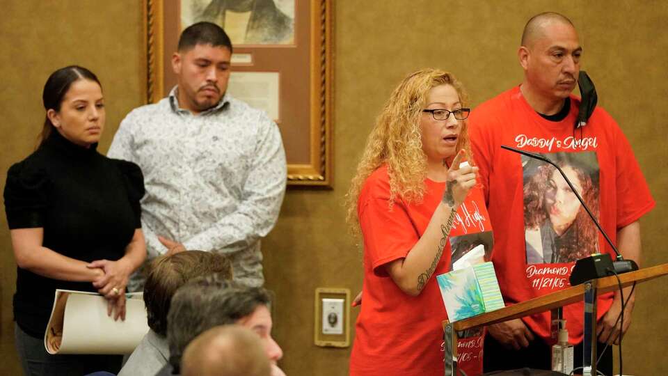 Anna Machado, second from right, with Tito Moczygemba, right, parents of Diamond Alvarez, 16, who died after being shot 22 times, speaks as Wendy Alvarez, left, and Armando Alvarez, parents of Arlene Alvarez, 9, who died after being shot, wait to speak during the Harris County Bail Bond Board meeting Wednesday, April 13, 2022, in Houston.The board voted on a proposal to set minimum 10 percent fee on bail bonds.