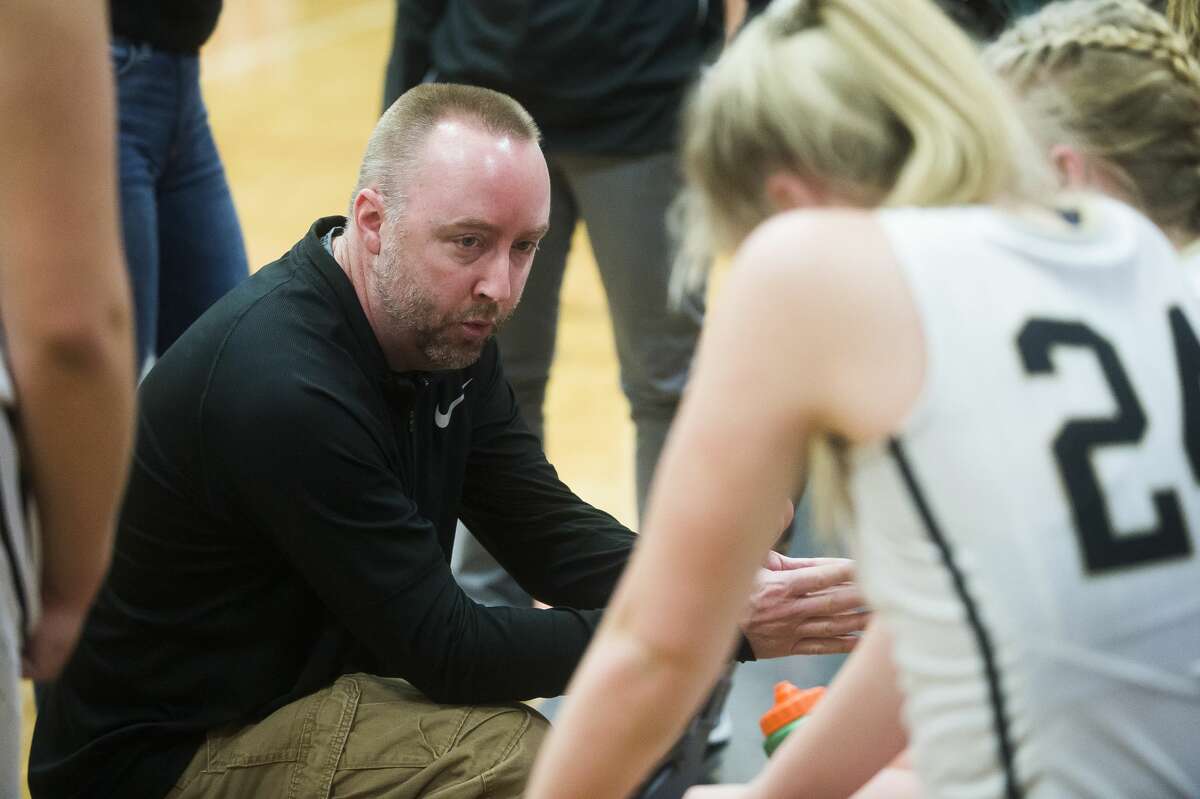 Bullock Creek coach Justin Freeland chats with his players during a timeout in a March 2, 2020 district game against Freeland.