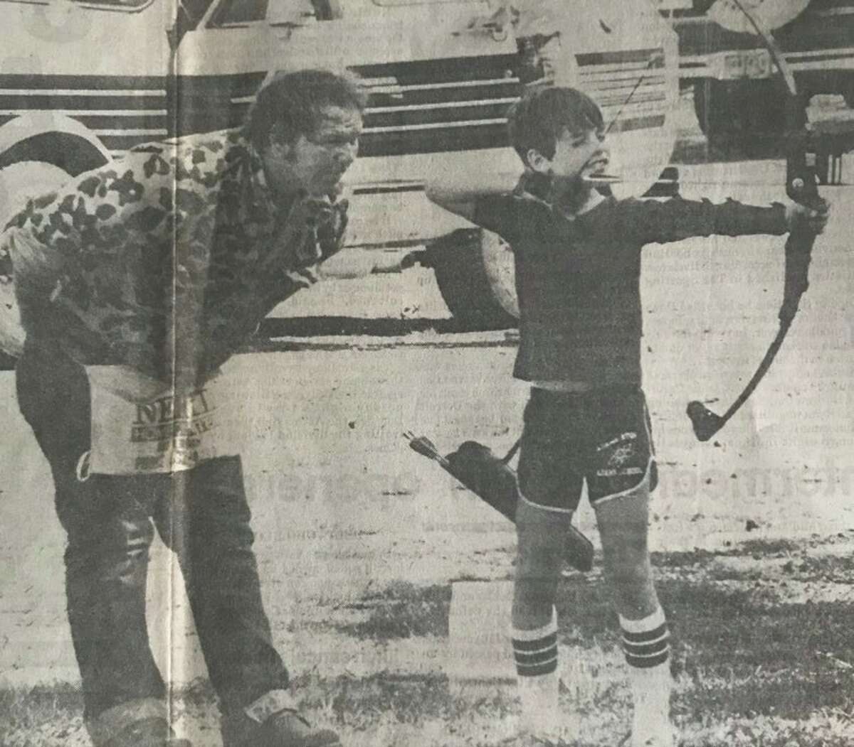 Douglas Schaffer, 9, of Midland, aims an arrow at a downrange target while club member Herschel Richardson offers advice. September 1983