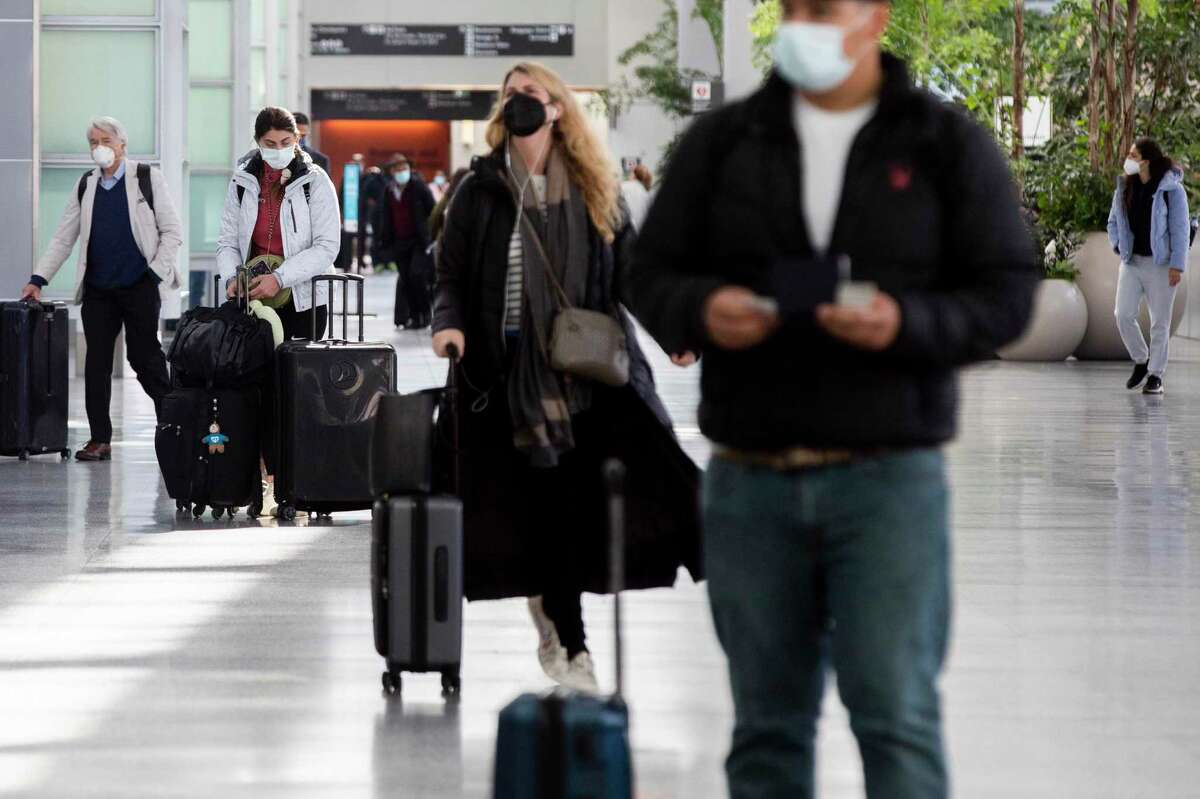 Airline mask mandates end at SFO after a judge’s ruling strikes down mask requirements on airplanes and public transportation. International travelers make their way through the international ticketing area at San Francisco International Airport in San Francisco, Calif. Airport officials said they were doing away with its mask mandate.