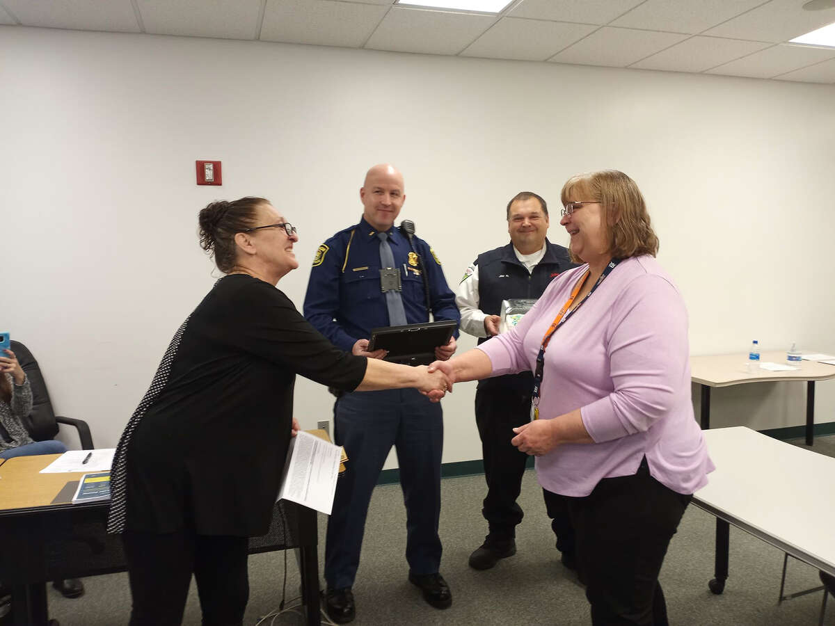 Lake County Commissioner Chris Balulis (left) congratulates Toni Jandron, recognizing her for going above and beyond as dispatcher. 