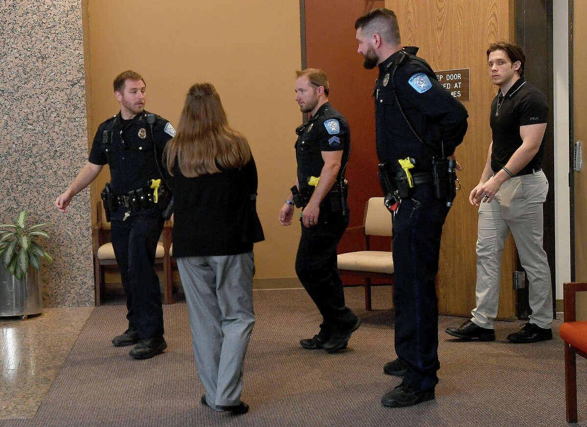 Members of the Beaumont Police Department and family of Officer Sheena Yarbrough - Powell exit an office in the Jefferson County Courthouse Tuesday after meeting with a member of the district attorney's office regarding Luis Torres' guilty plea just before the scheduled start of his trial. Torres will be back in court Wednesday for a second charge regarding the injury of Officer Gabriel Fells in the same drunk driving accident in 2020. . Photo made Tuesday April 19, 2022. Kim Brent/The Enterprise