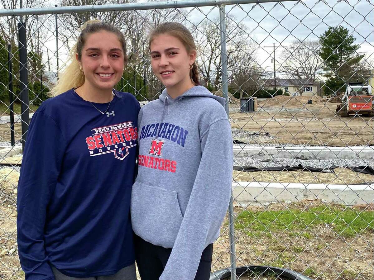McMahon softball captains Lucy Grillo and Lilly Sattler in front of the school’s softball field which is in the process of having turf and lights installed.