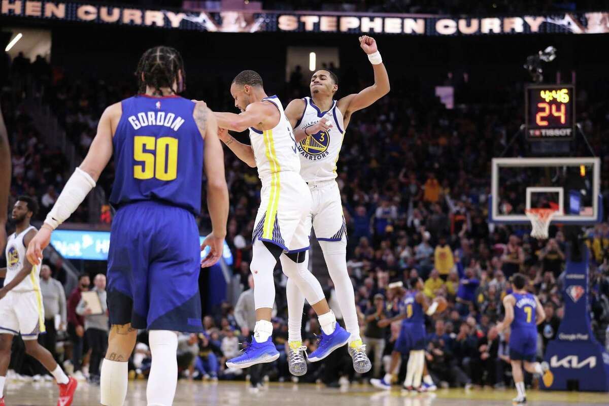 Golden State Warriors’ Jordan Poole and Stephen Curry celebrate a Curry basket in 4th quarter of Warriors’ 126-106 win over Denver Nuggets in Game 2 of NBA Western Conference 1st round playoff series at Chase Center in San Francisco, Calif, on Monday, April 18, 2022.