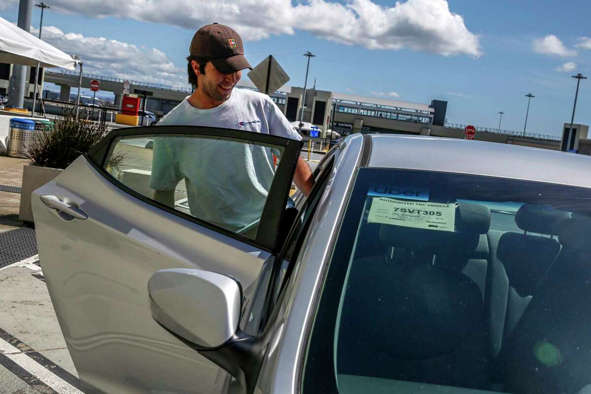 Visiting from Arizona, Ethan Williams gets in an Uber at Terminal 3 at San Francisco International Airport in San Francisco, Calif. on Tuesday, April 19, 2022.
