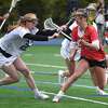 Darien's Kate Demark (23) defends against New Canaan's Dillyn Patten (3) during a girls lacrosse game in Darien on Tuesday, April 19, 2022.