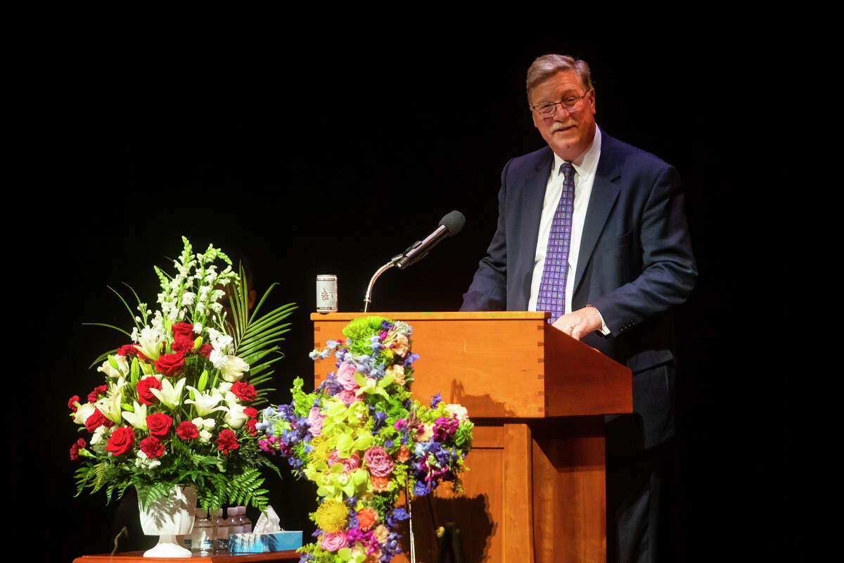 MyMichigan Health President and Chief Executive Officer Greg Rogers speaks about his late colleague, Diane Postler-Slattery, during a celebration of life Tuesday, April 19, 2022 at the Midland Center for the Arts in honor of Postler-Slattery and her husband, Don Slattery.