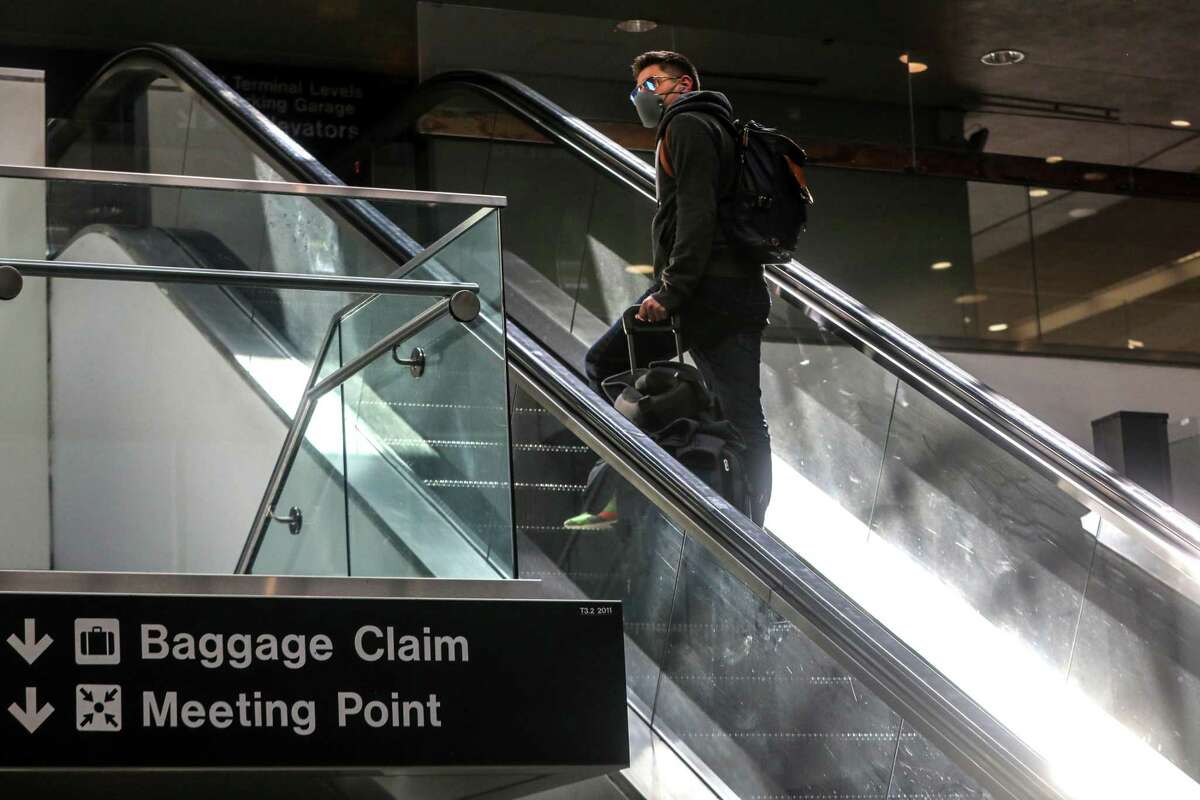 Travelers make their way toward security at Terminal 3 at San Francisco International Airport in April.