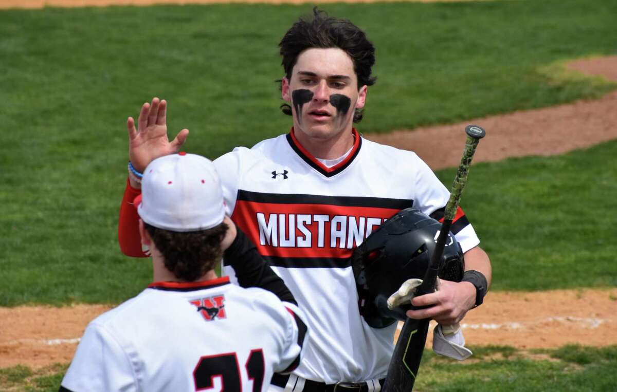 Fairfield Warde's Roman DiGiacomo high fives a teammate after scoring a run during a baseball game between Fairfield Warde and St. Joseph at Kiwanis Field, Fairfield on Monday, April 18, 2022.
