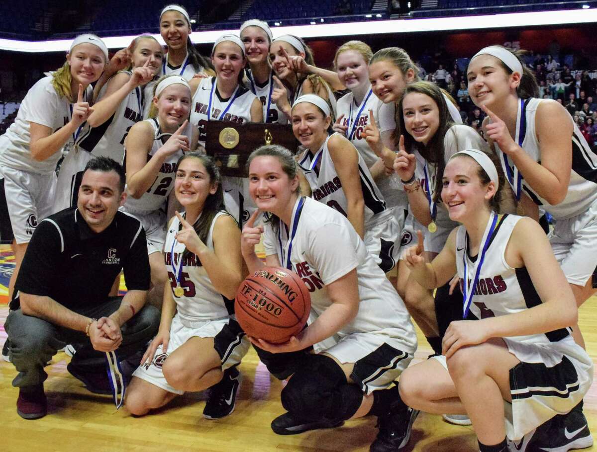 Canton celebrates with the Class S state championship plaque for the second straight year after beating Thomaston 60-51 at Mohegan Sun Arena on Saturday. (Derek Turner/GameTimeCT)