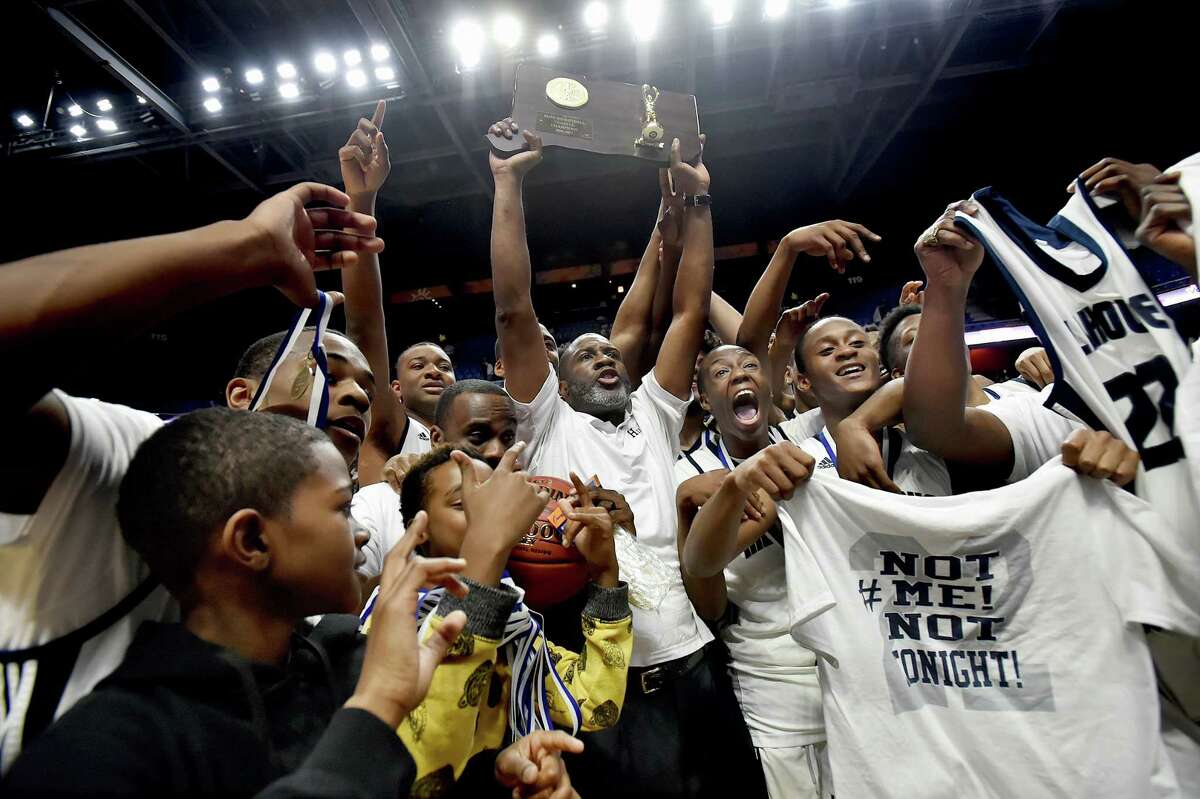 The Hillhouse Academics celebrates their back-to-back titles in the CIAC class LL state championship win defeating the East Hartford Hornets, 78-58, Saturday, March 18, 2017, at Mohegan Sun Arena in Uncasville. (Catherine Avalone/New Haven Register)