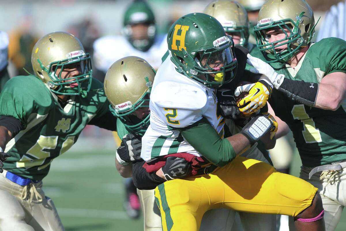 (Peter Casolino — New Haven Register) Hamden’s Keon Simpson gets wrapped up by the Notre Dame defense during the second quarter.