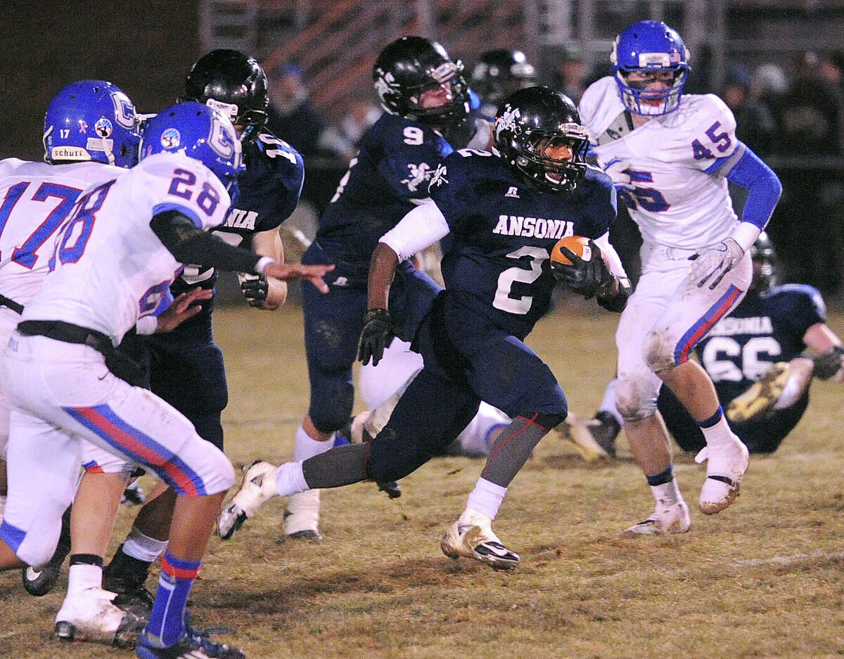 (Peter Casolino – New Haven Register) Ansonia’s Arkeel Newsome blasts through the Coginchaug line during the second quarter for an 82-yard Touchdown.