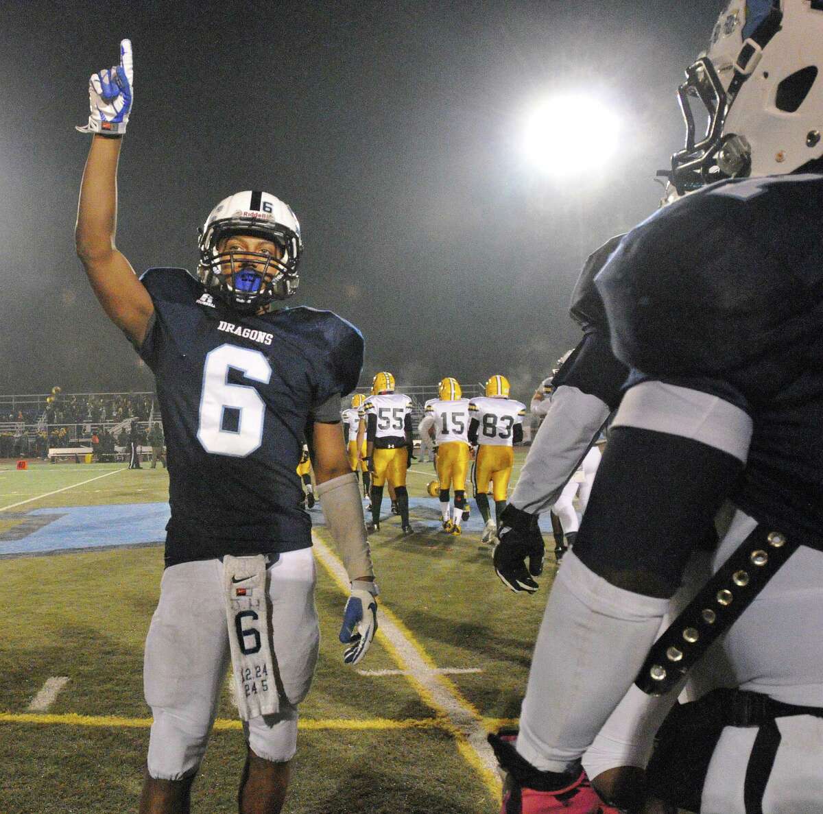 Middletown junior quarterback Dario R. Highsmith, Jr. acknowledges his teammates and fans following their 49-14 win over New London in the CIAC Class L quarterfinal game at Rosek-Skubel Stadium at MHS. Catherine Avalone – The Middletown Press