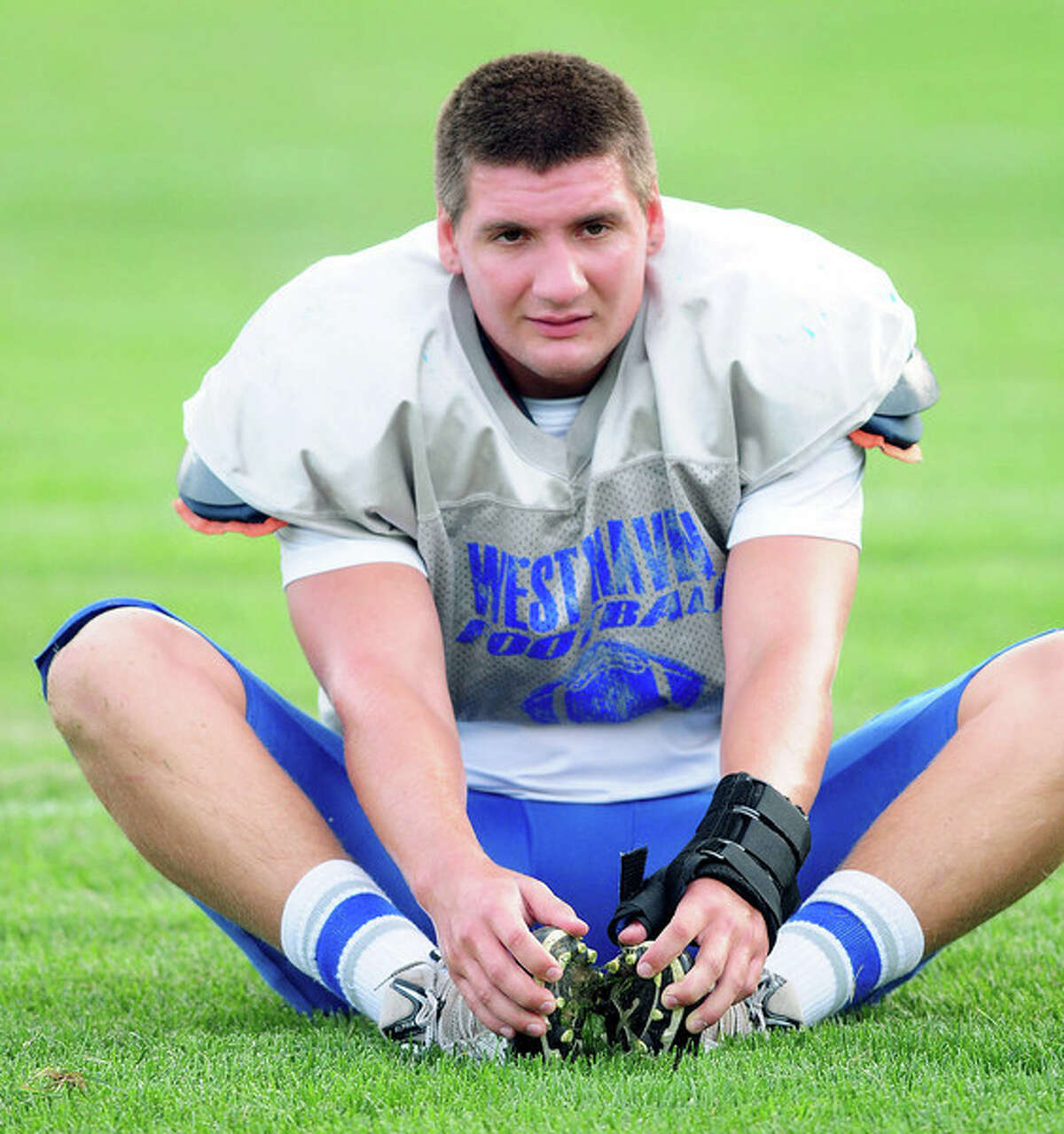West Haven linebacker Jesse Ridgway stretches before a game played earlier this year. He and the Westies continue to honor the memory of Ridgway’s sister, Casey, who died earlier this year. (Arnold Gold – New Haven Register)