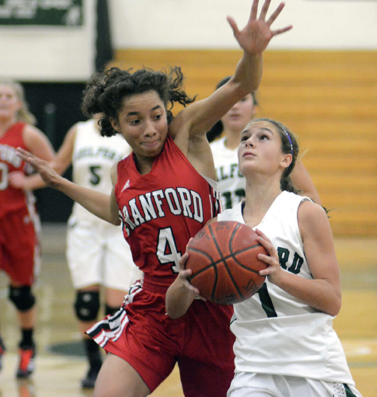 Photo by Dave Phillips/ Guilford’s Andrea Basilicato (1) eyes the basket as Branford’s Jade Maddox defends in Friday night’s game. Guilford won 39-38. Basilicato, a freshman, led the Indians with 10 points.