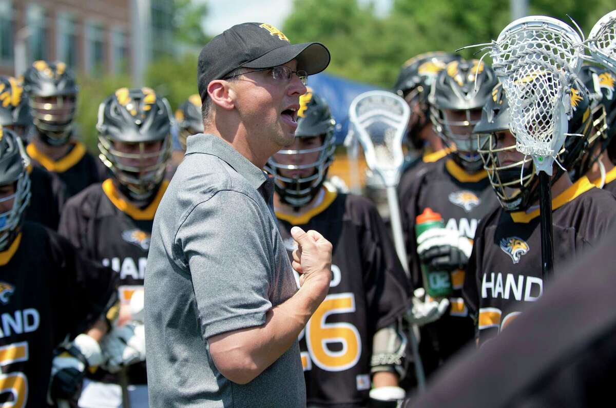 Daniel Hand head coach Paul Deon speaks with his team during the Class M Boys Lacrosse final between Daniel Hand and New Canaan at Brien McMahon High School in Norwalk, Conn., on Saturday, June 10, 2017.
