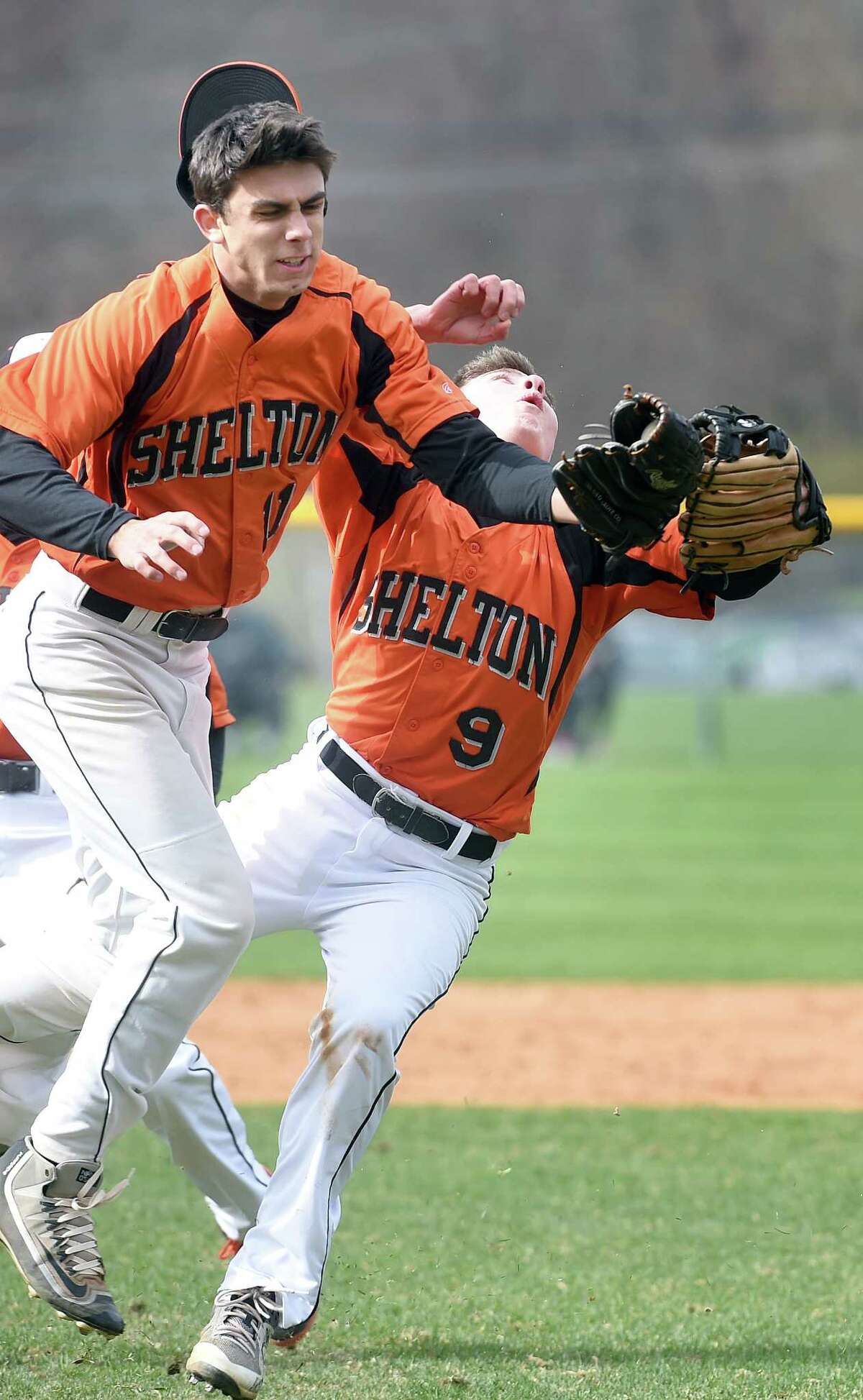 Shelton pitcher Will Ciccone (left) and Dylan DeSio collide while fielding a pop up in the infield against Amity in Woodbridge on April 30, 2018. Ciccone made the catch.