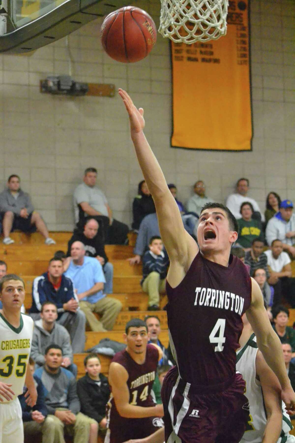 Torrington’s John McCarthy goes for a layup during the Red Raiders 69-55 win over Holy Cross. McCarthy scored a game high 24 points.