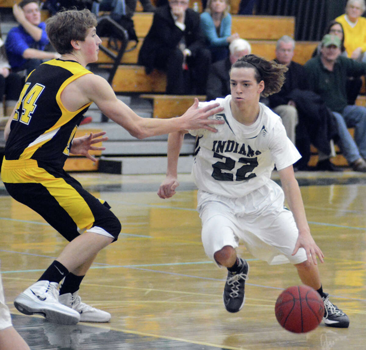Photo by Dave Phillips/ Guilford’s Shaun Ross looks to dribble past Amity’s Chris Winkel earlier this season.