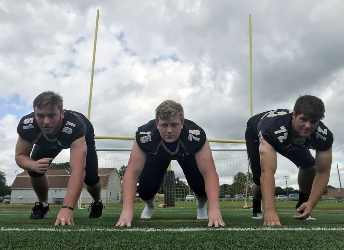 Hand’s fearsome threesome, defensive linemen (from left) Jack Flanagan (51), Macken McDonald (75) and Ben Corniello return to anchor the vaunted Hand defense (Photo Sean Patrick Bowley / Hearst Connecticut Media)