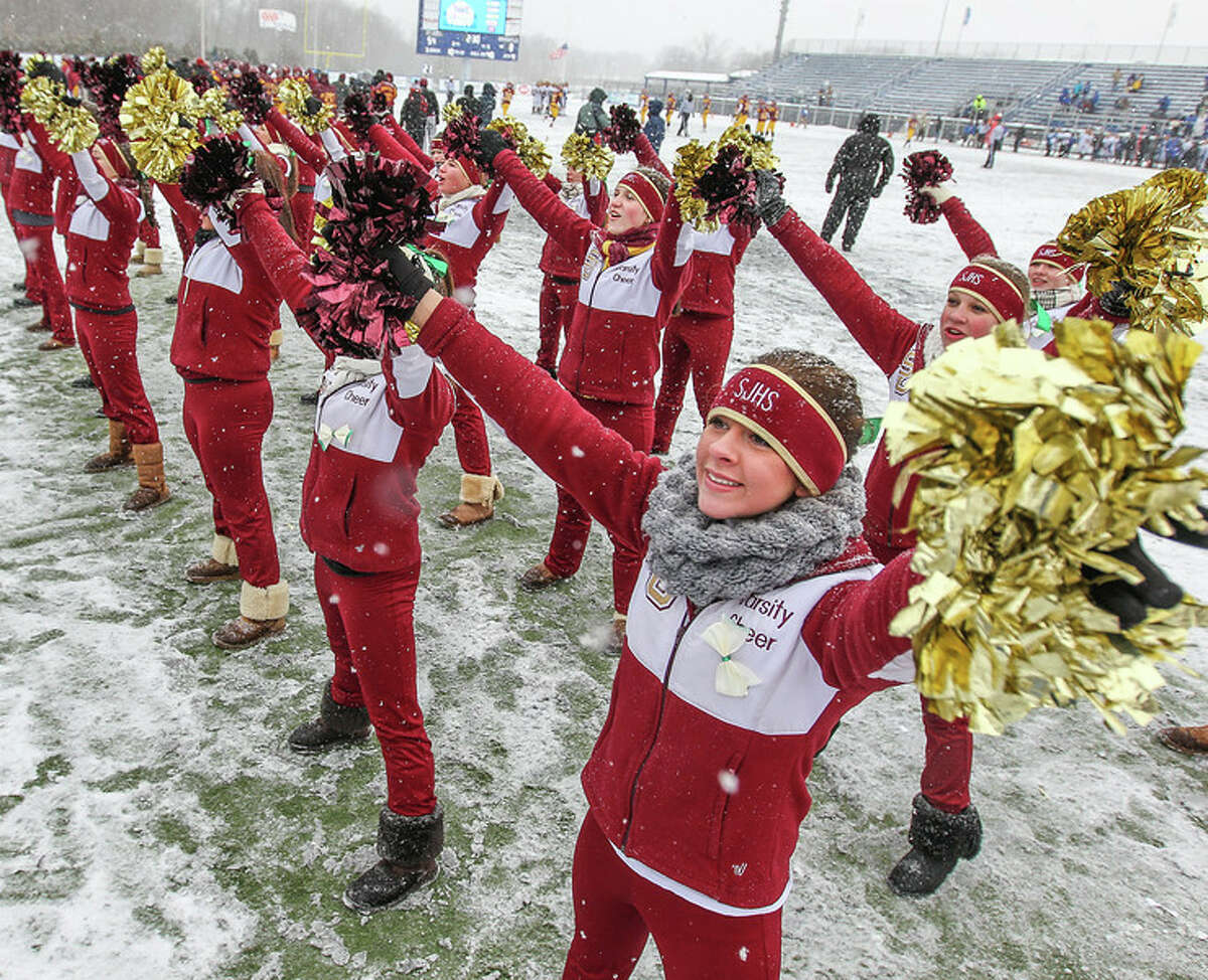 St. Joseph cheerleaders brave cold and snowy conditions to perform during the Class M championship game on Dec. 14. The threat of inclement weather for games played deep into December is one of the reasons the CIAC believes the high school football playoff system should change. (Photo John Vanacore)